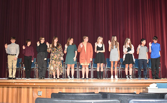 students taking the NJHS pledge on stage