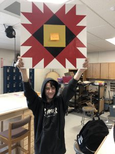 Student holds up project to show everybody