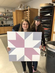 Student shows the colorful square