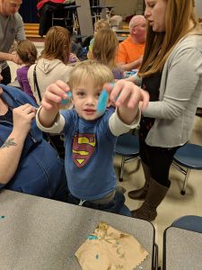 Student holds up slime